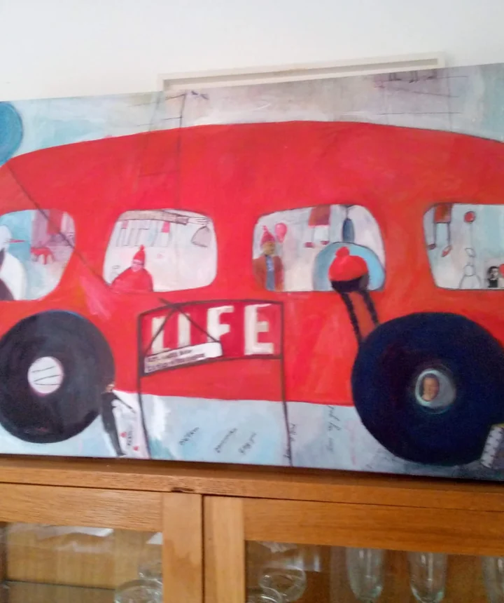 Large red bus painting with small figures inside and around the windows.