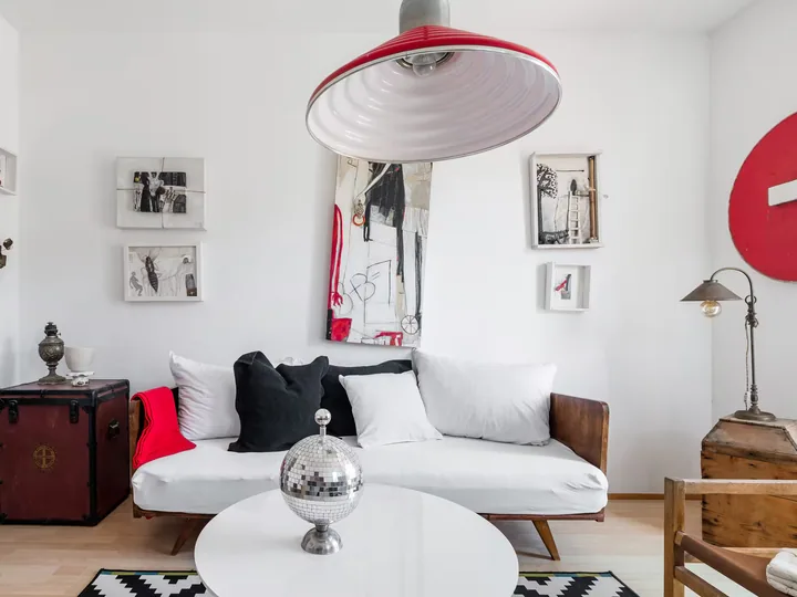 A wide living room interior with prints on the walls.