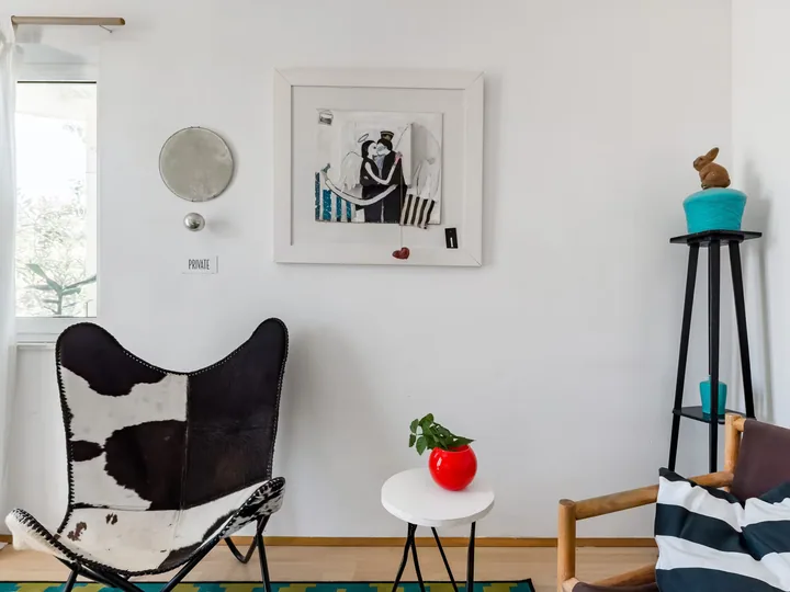 A framed work displayed in a lounge interior.