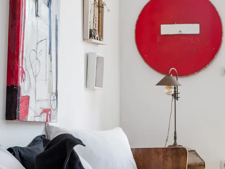 A red circular painting hanging in a room.
